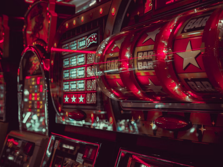 A close-up of a slot machine with BAR symbols and bright red lights