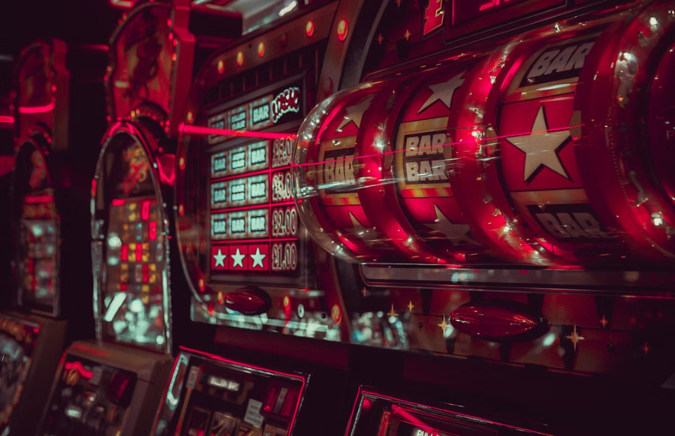 A close-up of a slot machine with BAR symbols and bright red lights